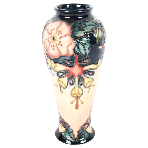 681 - A Moorcroft tube-lined baluster vase with floral design, 20cm