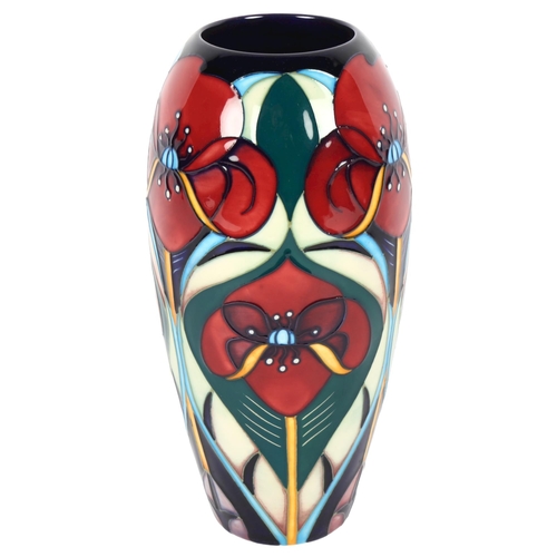 683 - A Moorcroft tube-lined baluster vase, with stylised poppy decoration, 18.5cm