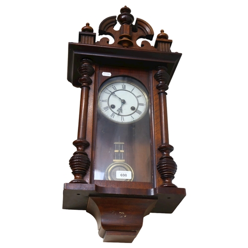 698 - A 2-train wall clock in ornate carved frame, height 66cm