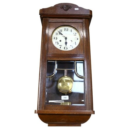 700 - An oak-cased 8-day wall clock, height 74cm