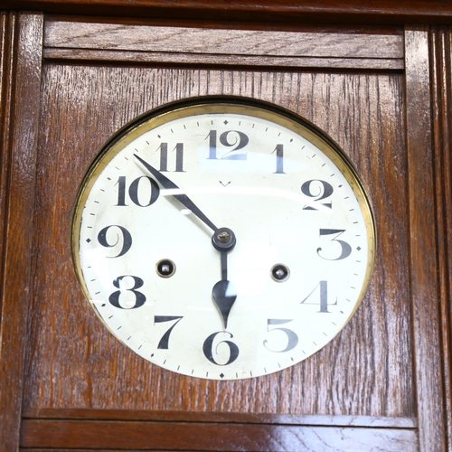 700 - An oak-cased 8-day wall clock, height 74cm