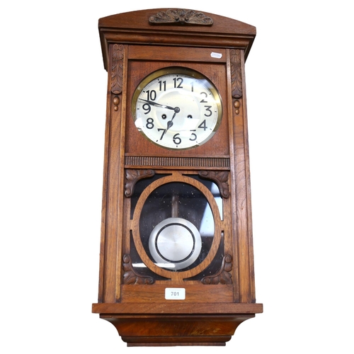 701 - An oak-cased 8-day wall clock, 73cm