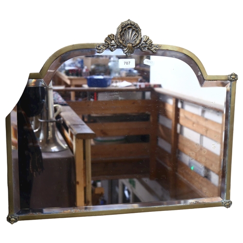 707 - An Antique brass-framed bevel-edge mirror with shell motif, 57cm across