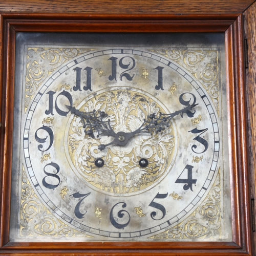 712 - A square oak-cased 2-train wall clock, with engraved dial, 37cm