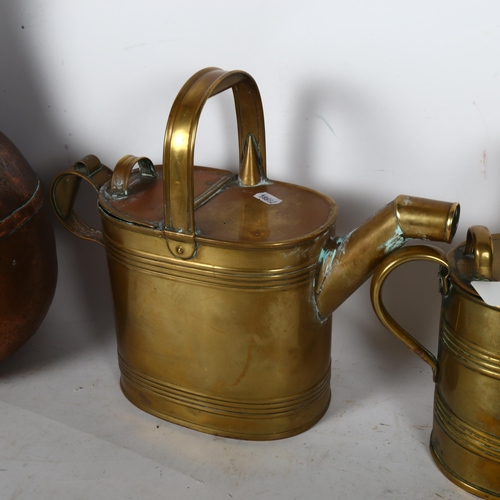 759 - A 19th century hammered copper pitcher/jug with lid, 2 brass watering cans, largest 40cm