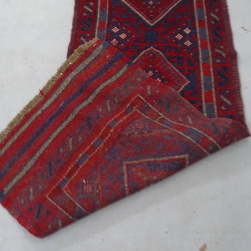 2334 - A red ground Meshwani runner, 244 x 59cm