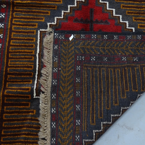 2336 - A red ground Beluchi rug, 143 x 88cm