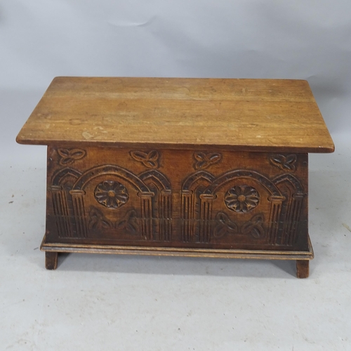 2299 - An Arts and Crafts style carved oak blanket box raised on stile legs. 89cm x 52cm x 36cm