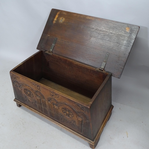 2299 - An Arts and Crafts style carved oak blanket box raised on stile legs. 89cm x 52cm x 36cm