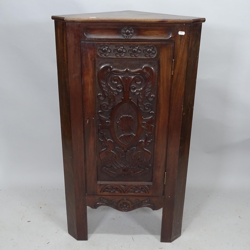 2303 - An oak corner cupboard with single panelled door with applied carved decoration. 64cm x 105cm x 40cm