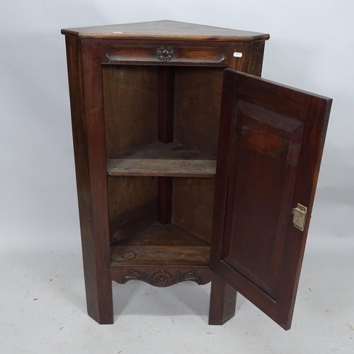 2303 - An oak corner cupboard with single panelled door with applied carved decoration. 64cm x 105cm x 40cm