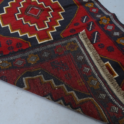 2304 - A red-ground Baluchi rug, 140cm x 92cm