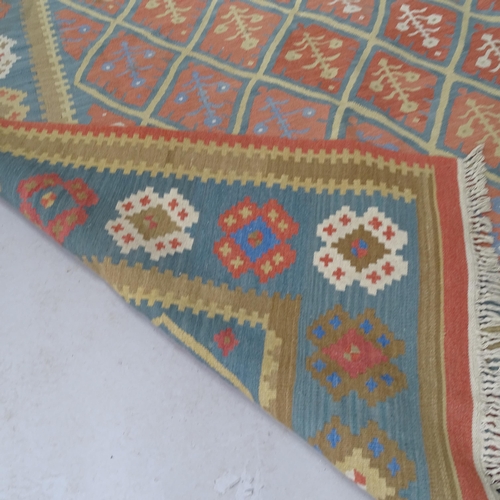 2317 - A blue and cream ground leaf design Kilim rug. 247cm x 170cm