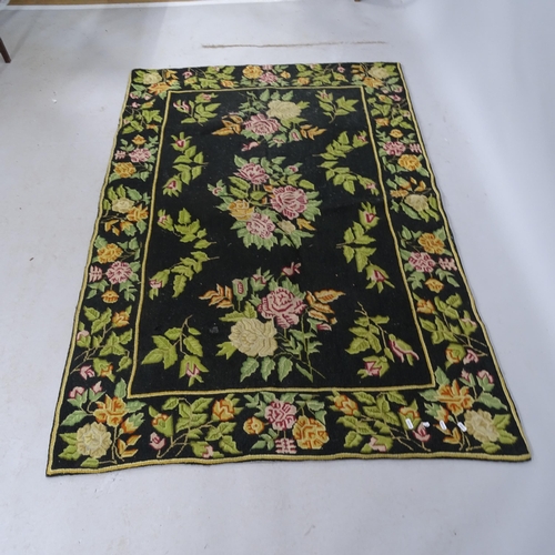 2318 - A black-ground floral design Aubusson rug 177cm x 118cm