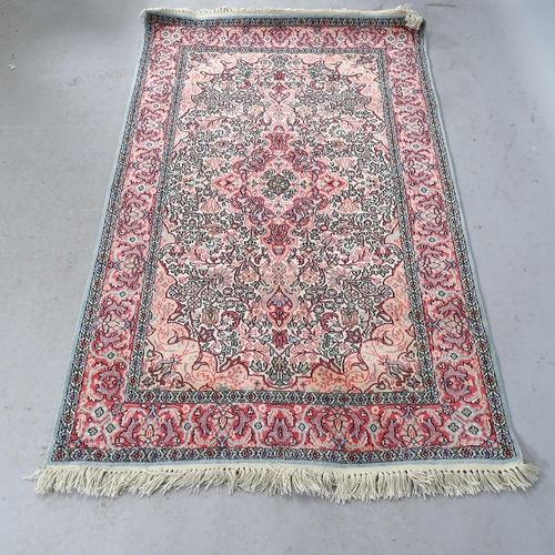 2319 - A salmon-ground Indian design silk rug. 150cm x 93cm