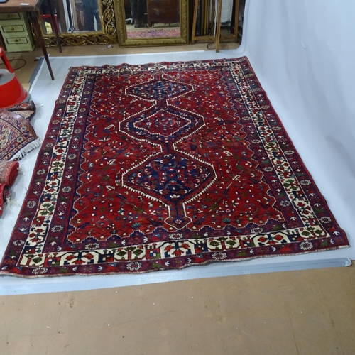 2322 - A red-ground Iranian Bownat design carpet. 240cm x 180cm