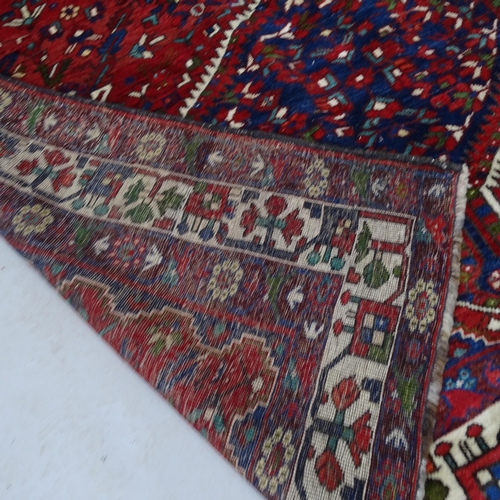 2322 - A red-ground Iranian Bownat design carpet. 240cm x 180cm