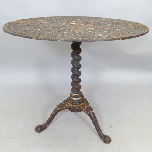 2649 - A cast iron garden table with pierced top and raised on barley twist column on tripod base. 80cm x 7... 