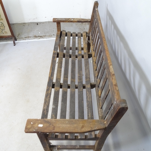 2672 - A vintage stained teak slatted garden bench. 160cm x 84cm x 60cm