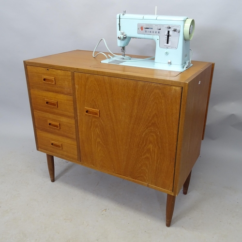 2677 - A mid-century Singer Sewing machine mounted on a teak work table. 85cm x 76cm x 45cm