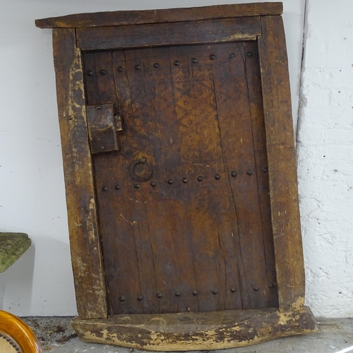 2690 - A small antique oak door and frame. Overall 90cm x 132cm