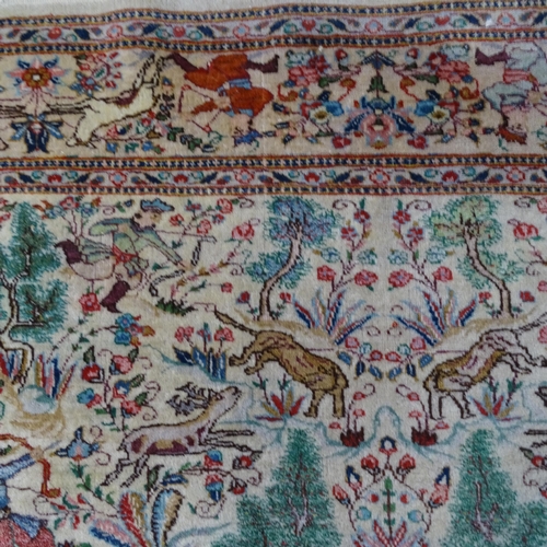 2341 - An Iranian cream-ground rug, the central lozenge and borders decorated with hunting scenes. 215cm x ... 