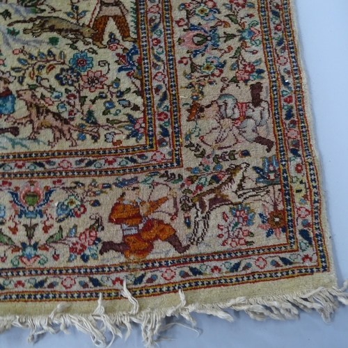 2341 - An Iranian cream-ground rug, the central lozenge and borders decorated with hunting scenes. 215cm x ... 