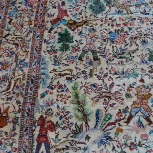 2341 - An Iranian cream-ground rug, the central lozenge and borders decorated with hunting scenes. 215cm x ... 