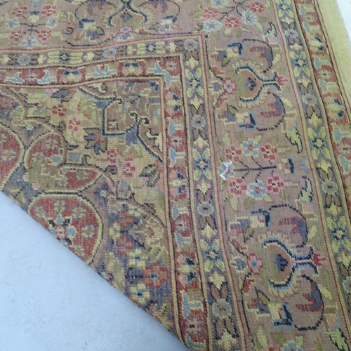 2342 - A red and cream ground Iranian Tabriz carpet with symmetrical floral decoration. 270cm x 175cm