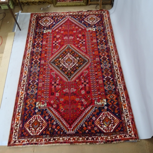 2344 - A red-ground Hamadan carpet. 275cm x 180cm