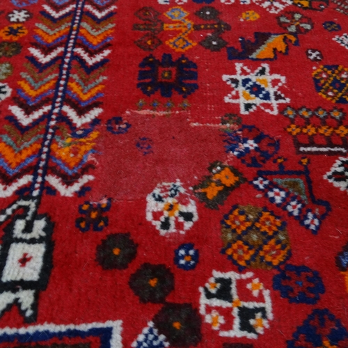 2344 - A red-ground Hamadan carpet. 275cm x 180cm