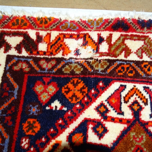 2344 - A red-ground Hamadan carpet. 275cm x 180cm