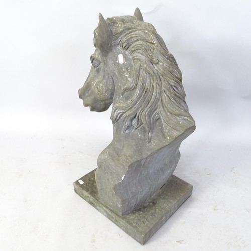 2352 - A heavy carved granite horse's head with attached plinth. H - 66cm.