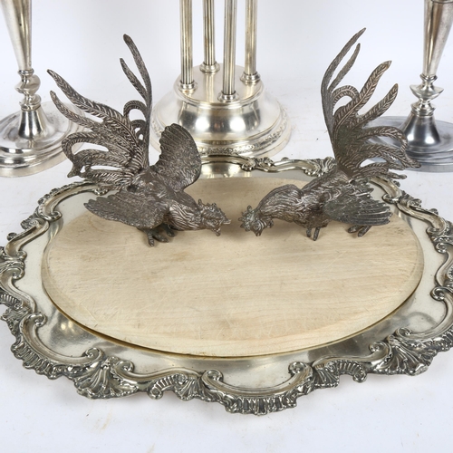 913 - A pair of silver plated 2-branch candelabras, a bread board in plated stand, a table stand on 4-pill... 