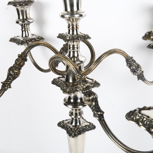 915 - A large silver plate on copper 4-branch table candelabra, height 50cm (middle sconce missing)