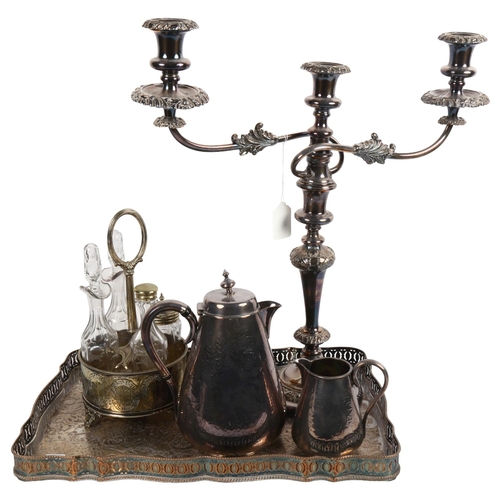 919 - A rectangular silver plated serving tray with raised gallery, a 2-branch table candelabra, condiment... 