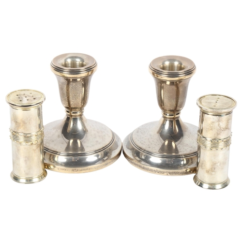 954 - A pair of squat silver candlesticks, height 9cm, and a pair of silver plated pepper pots by Vera Wan... 