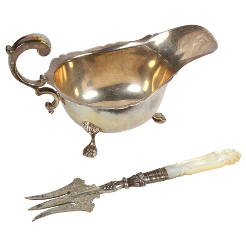 981 - A George VI silver cream jug, Birmingham 1937, and an Edward VII silver and mother-of-pearl handled ... 