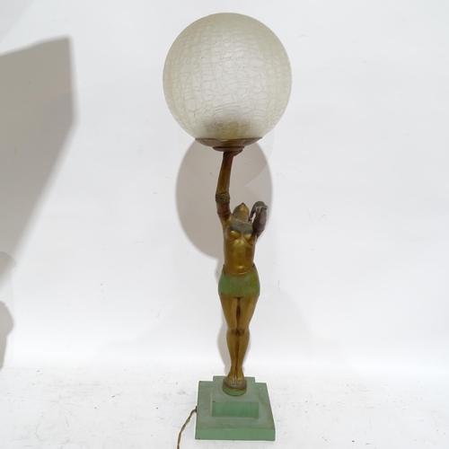 406 - An Art Deco gilded spelter figure holding a globular glass light shade on stepped plinth, height 62c... 