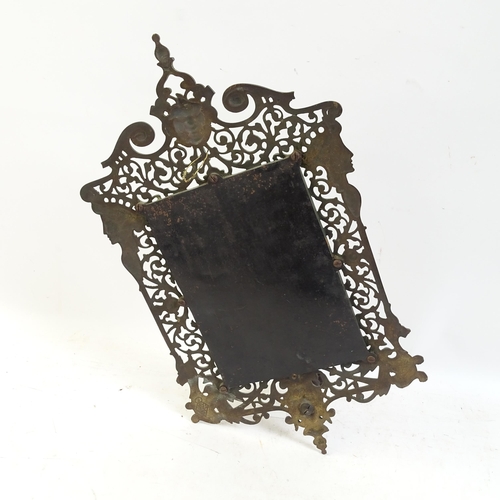 98 - A pierced and engraved cast-metal bevel-edge wall mirror, with single sconce and decorated with drag... 