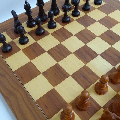 566 - A modern turned wood chess set, complete with 32 pieces and chess board, King height 11cm