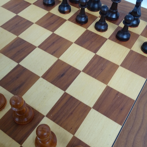 566 - A modern turned wood chess set, complete with 32 pieces and chess board, King height 11cm