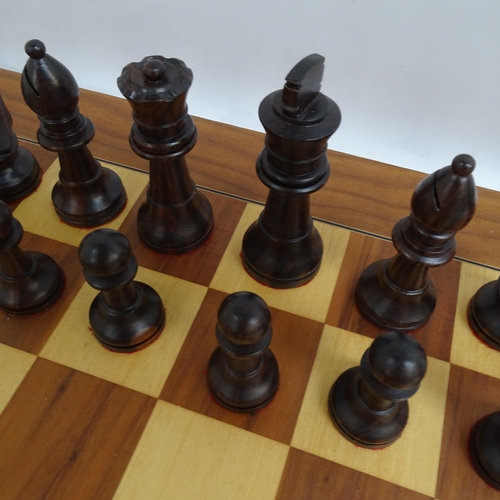 566 - A modern turned wood chess set, complete with 32 pieces and chess board, King height 11cm