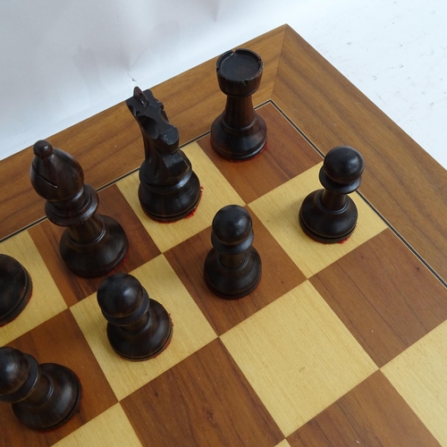 566 - A modern turned wood chess set, complete with 32 pieces and chess board, King height 11cm