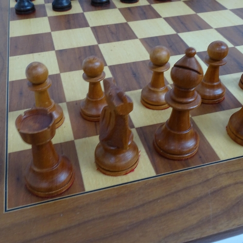 566 - A modern turned wood chess set, complete with 32 pieces and chess board, King height 11cm