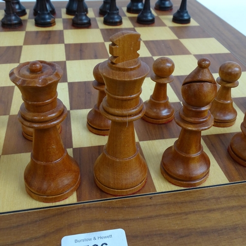 566 - A modern turned wood chess set, complete with 32 pieces and chess board, King height 11cm