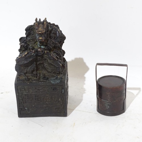 131 - A Chinese patinated bronze desk seal with dragon mount, height 17cm, and a small Chinese bronze sect... 