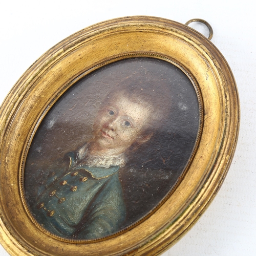 101 - An 18th century miniature oil on board, portrait of a child wearing a blue coat, inscribed verso Joh... 