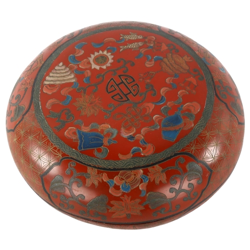 112 - A Chinese red lacquer circular box with painted decoration, diameter 17cm