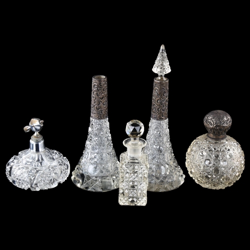 116 - A group of cut-glass perfume bottles, including 3 with silver mounts, largest height 23cm